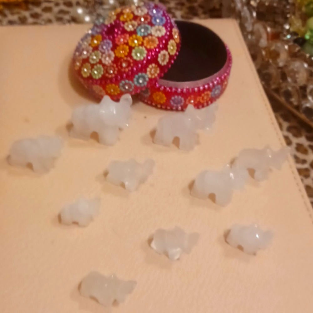 Trinket box with 10 marble elephants.